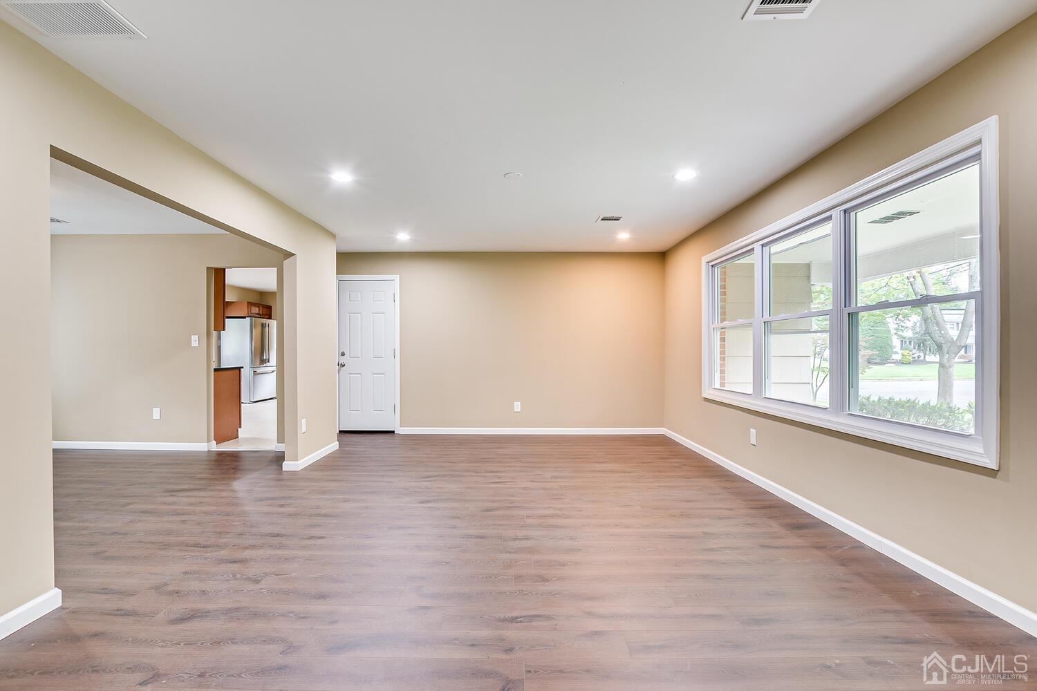 1 Lynnwood Road Edison, NJ 08820 - Photo 8 of 41 a view of an empty room with wooden floor and a window