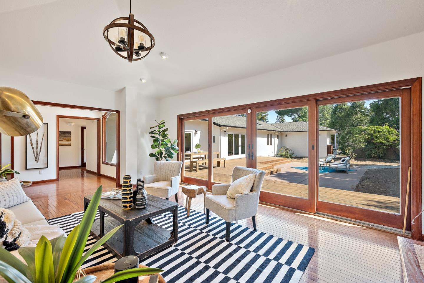 425 Covington Road Los Altos, CA 94024 - Photo 14 of 65 a living room with furniture a dining table and a floor to ceiling window
