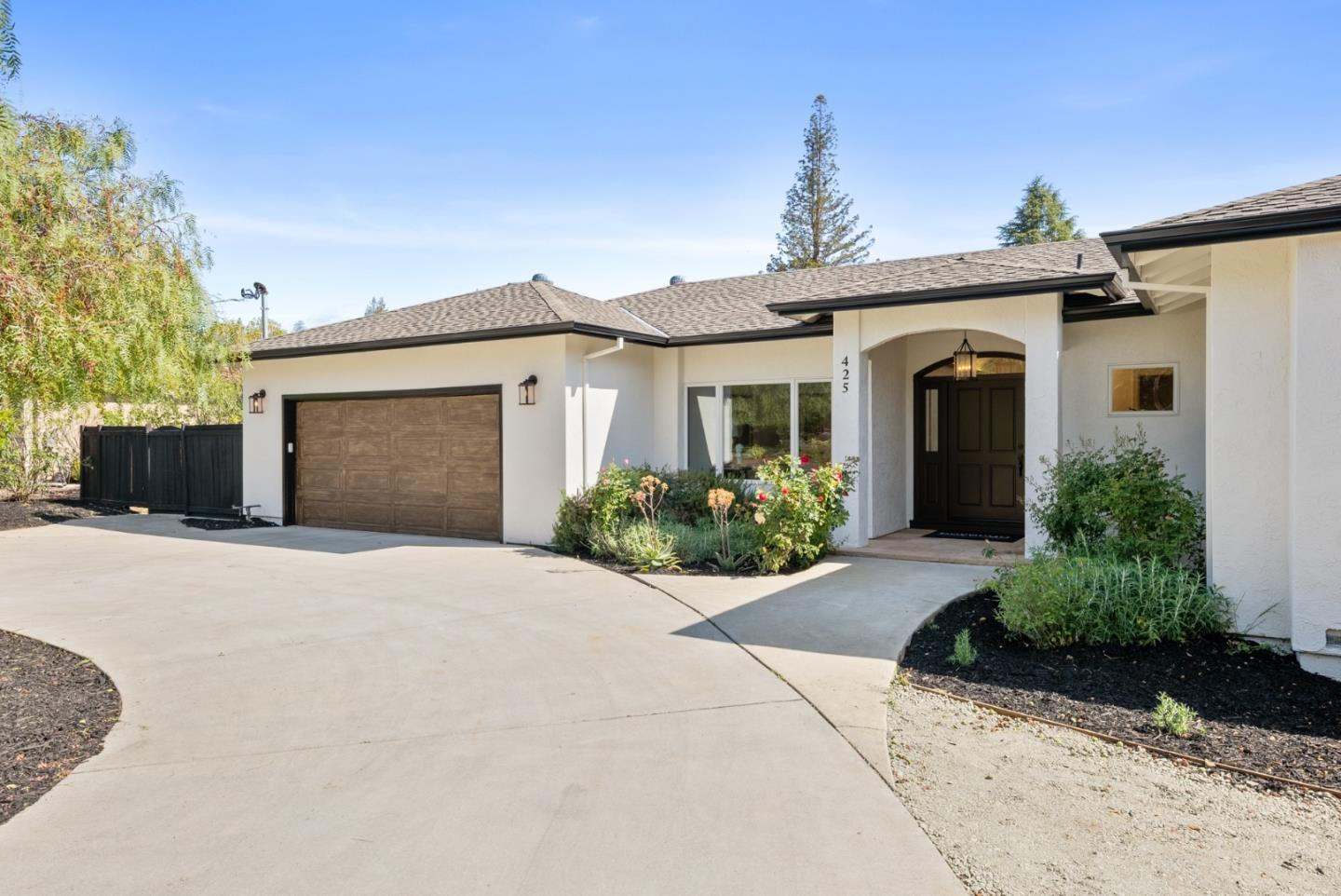 425 Covington Road Los Altos, CA 94024 - Photo 4 of 65 a front view of a house with a yard and a garage