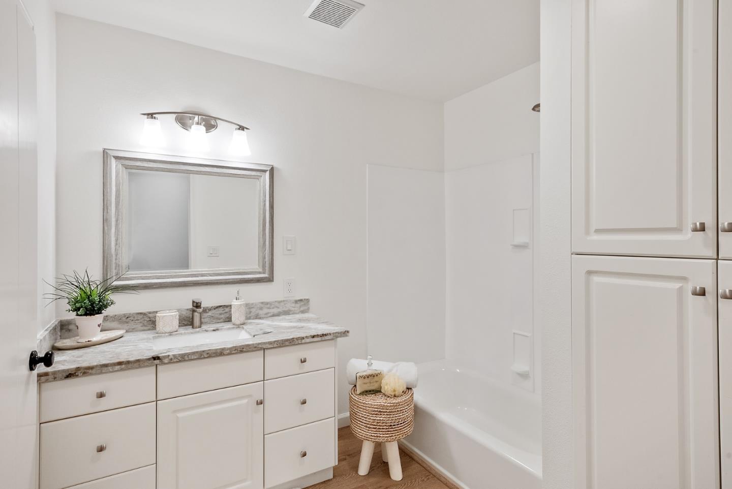425 Covington Road Los Altos, CA 94024 - Photo 41 of 65 a bathroom with a sink vanity granite tub and a mirror