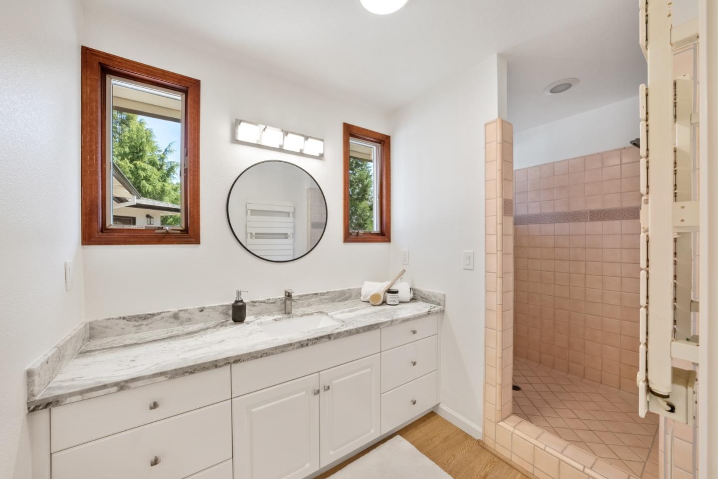 425 Covington Road Los Altos, CA 94024 - Photo 42 of 65 a bathroom with a granite countertop double vanity sink and a mirror