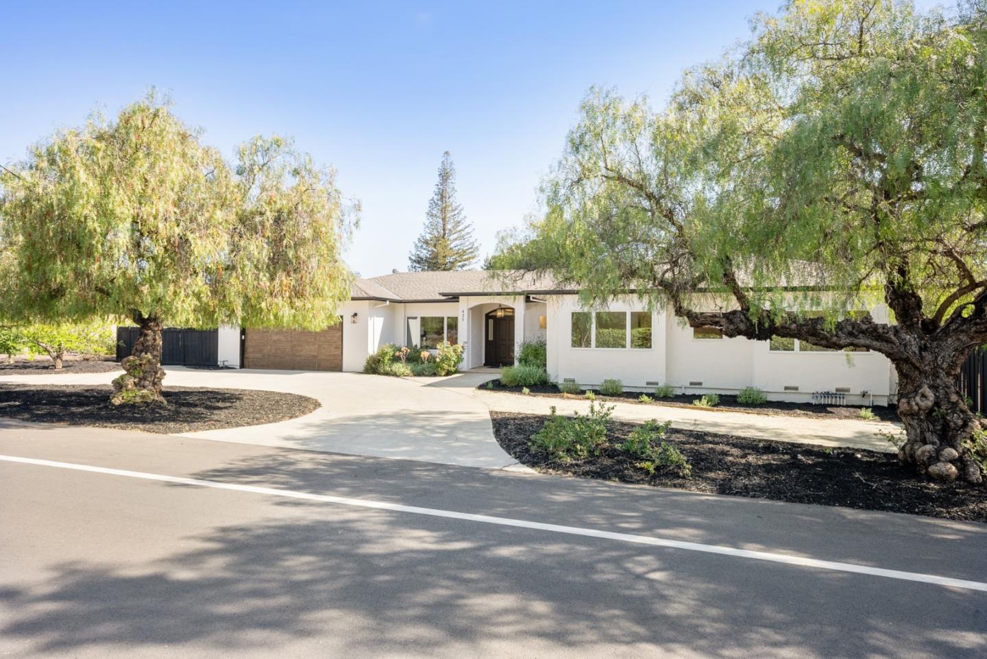 425 Covington Road Los Altos, CA 94024 - Photo 6 of 65 a front view of a house with a yard and garage
