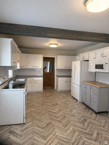 287 100 North Orem, UT 84057 - Photo 5 of 18 Kitchen with tasteful backsplash, white appliances, beam ceiling, white cabinetry, and gray cabinetry