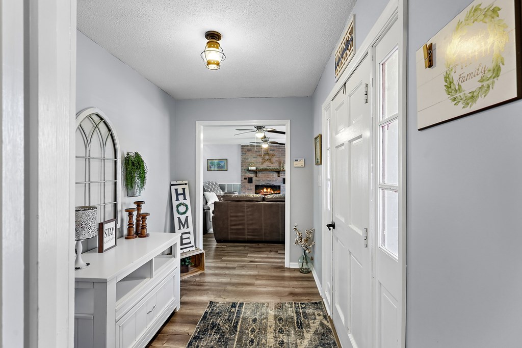 202 Wilton Road Abbeville, SC 29620 - Photo 11 of 35 The inviting entryway features durable flooring, leading into a spacious living area with a fireplace.