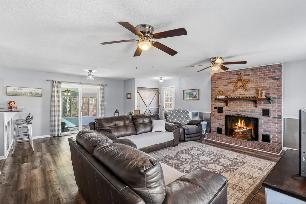 202 Wilton Road Abbeville, SC 29620 - Photo 13 of 35 This inviting living space features a cozy fireplace and convenient access to an outdoor area.