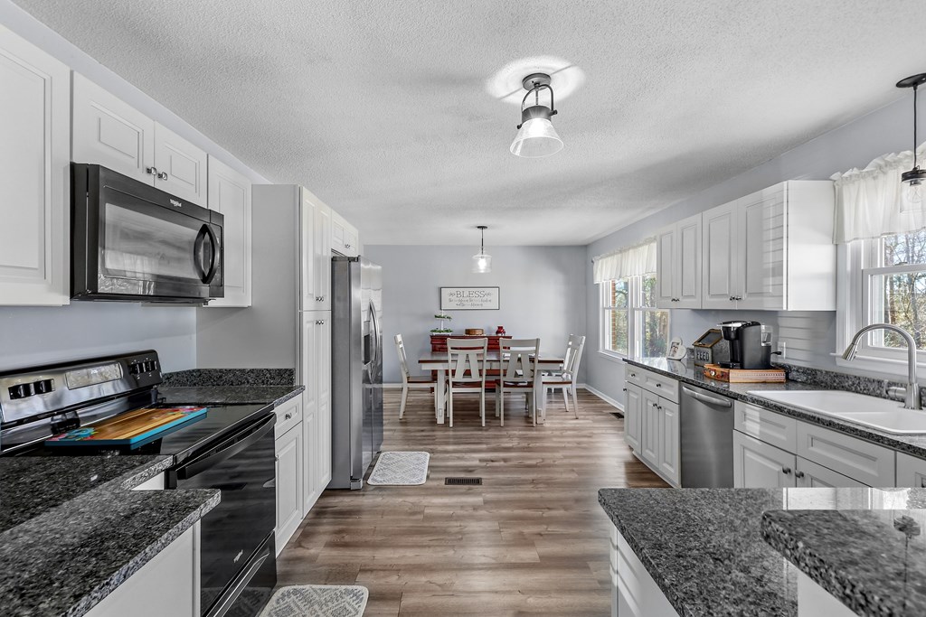 202 Wilton Road Abbeville, SC 29620 - Photo 18 of 35 This spacious kitchen and dining area offers ample counter space and abundant natural light.