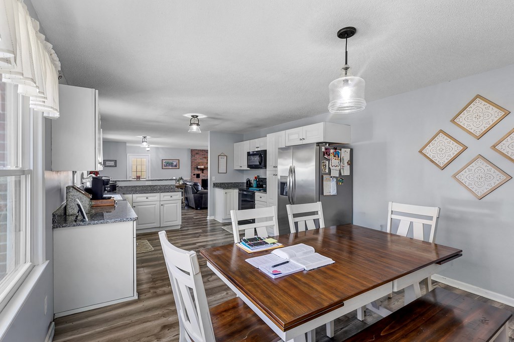 202 Wilton Road Abbeville, SC 29620 - Photo 22 of 35 This spacious kitchen and dining area features granite counters and modern appliances, perfect for everyday living.