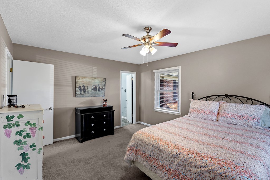 202 Wilton Road Abbeville, SC 29620 - Photo 23 of 35 This cozy bedroom features a window for natural light and convenient access to an en-suite bathroom.