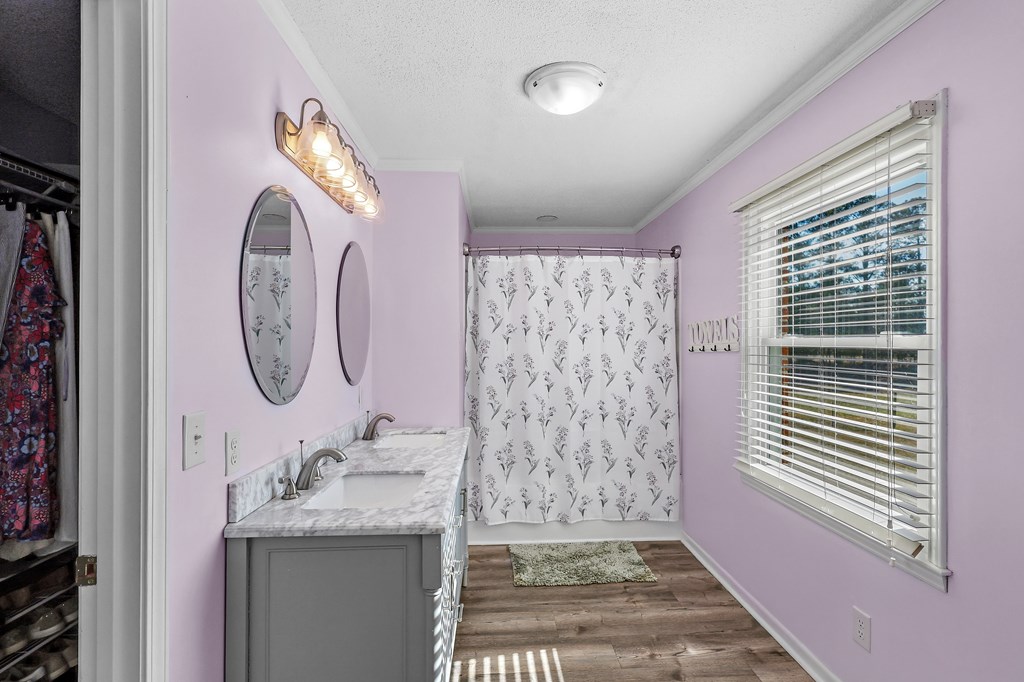 202 Wilton Road Abbeville, SC 29620 - Photo 27 of 35 This bright bathroom features a spacious dual vanity and convenient walk-in closet access.