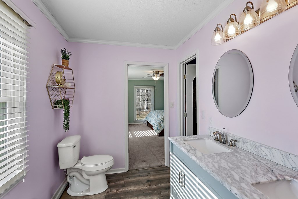 202 Wilton Road Abbeville, SC 29620 - Photo 28 of 35 This bathroom features a double vanity and a window with blinds, creating a bright and functional space.