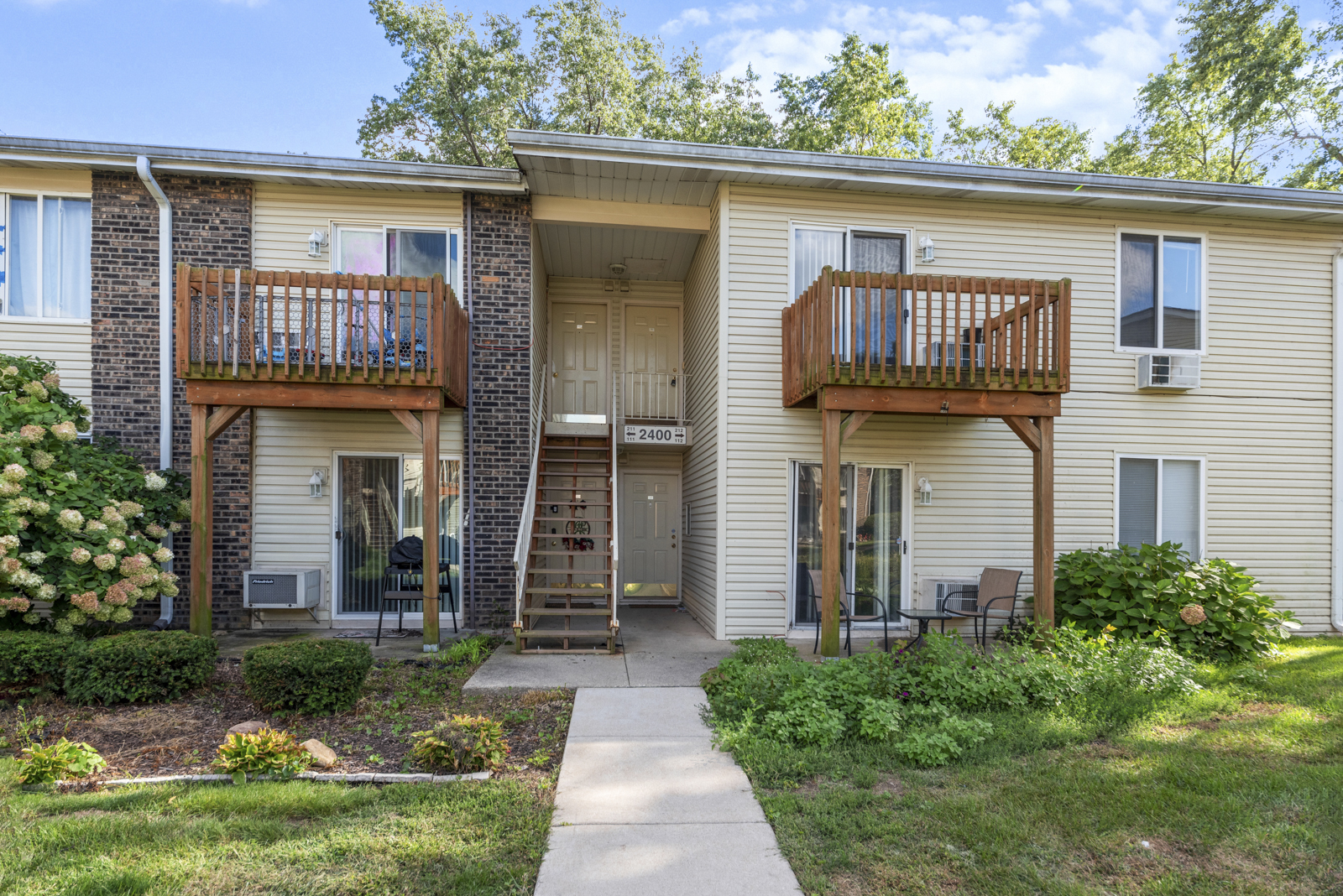 2400 Light Road, Unit 212 Oswego, IL 60543 - Photo 1 of 14 a front view of a house with garden