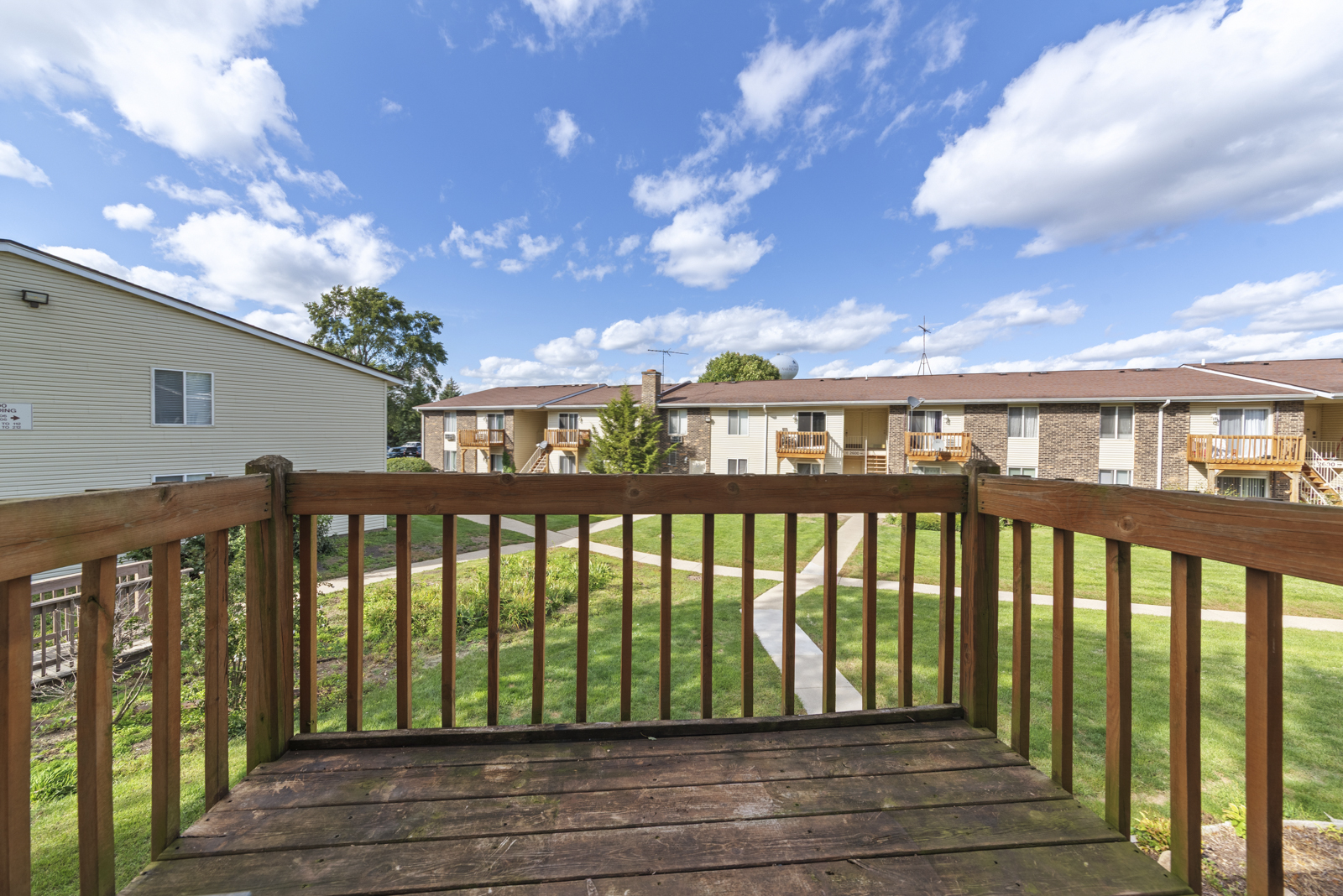2400 Light Road, Unit 212 Oswego, IL 60543 - Photo 14 of 14 a balcony with wooden floor and fence
