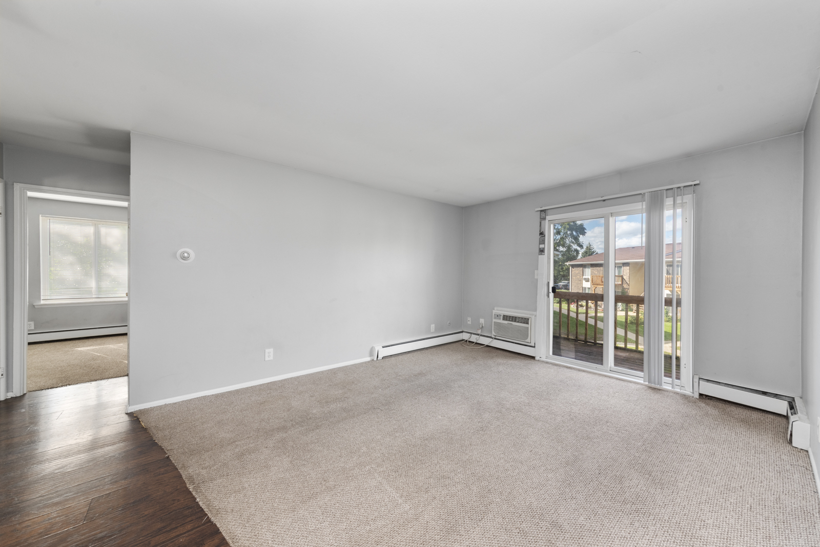 2400 Light Road, Unit 212 Oswego, IL 60543 - Photo 6 of 14 an empty room with wooden floor and windows