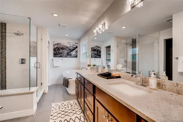 a bathroom with double vanity sinks and a mirror