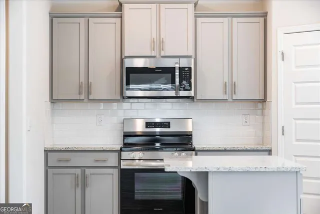 a kitchen with stainless steel appliances a sink stove and refrigerator