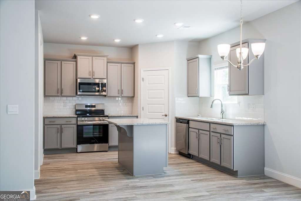 219 Carsons Walk Macon, GA 31206 - Photo 17 of 57 a kitchen with stainless steel appliances a sink stove and refrigerator