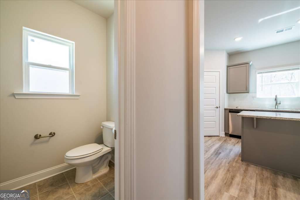 219 Carsons Walk Macon, GA 31206 - Photo 23 of 57 a bathroom with a toilet a sink and a window