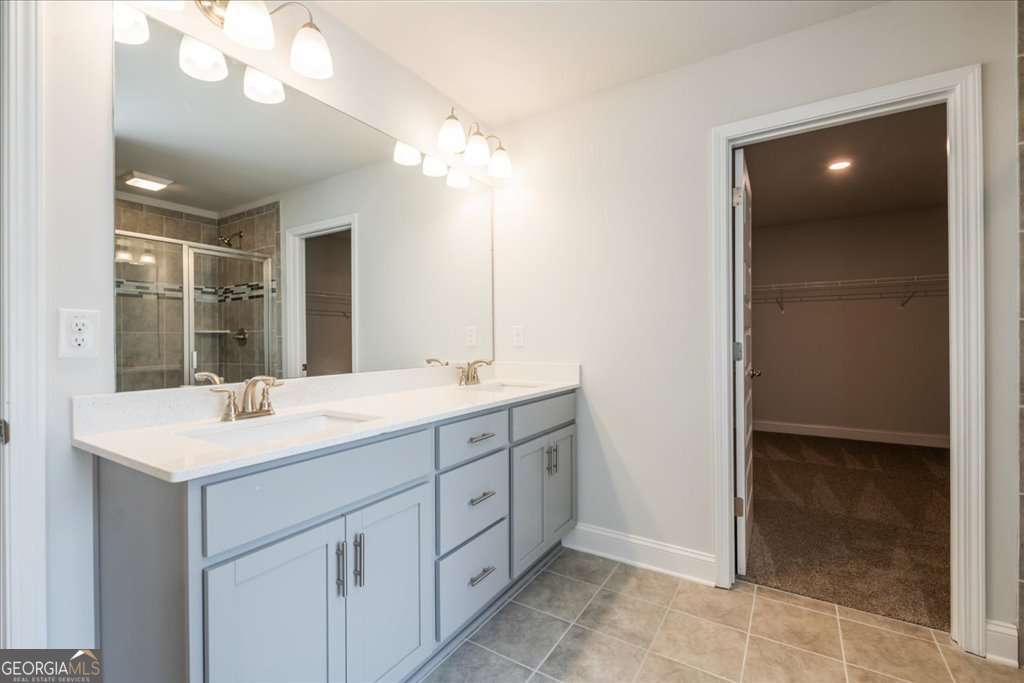 219 Carsons Walk Macon, GA 31206 - Photo 30 of 57 a bathroom with a sink a mirror and a shower