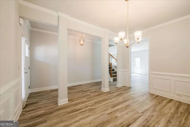 a view of a room with wooden floor and staircase