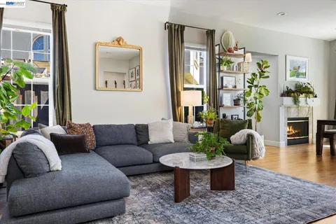 a living room with furniture and a potted plant