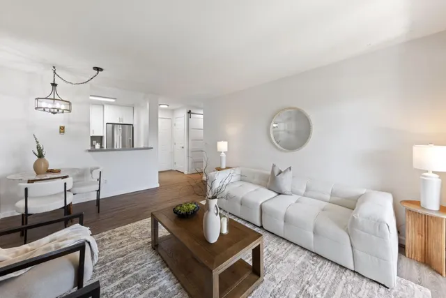 a living room with furniture and a mirror