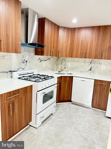 a kitchen with granite countertop cabinets stainless steel appliances and a sink