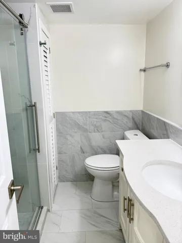 a white toilet sitting next to a bathroom sink