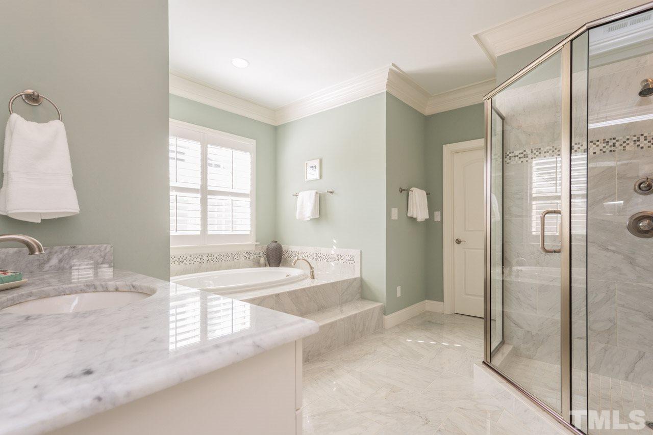 5012 Pomfret Point Raleigh, NC 27612 - Photo 11 of 25 The master bath is simply....perfect! Truly a spa-like setting! Extensive crown molding frames the room. There is a soaking tub and a large walk in shower with beautiful tile surround.