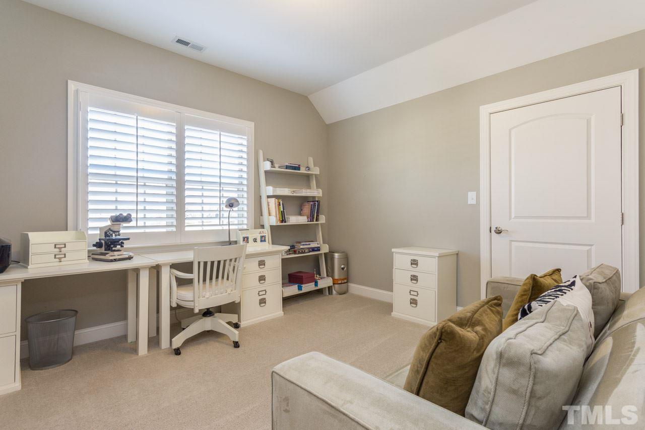 5012 Pomfret Point Raleigh, NC 27612 - Photo 17 of 25 Bedroom #4 is currently being used as an office. It offers a large walk in closet, plantation shutters, and access to a walk in attic.