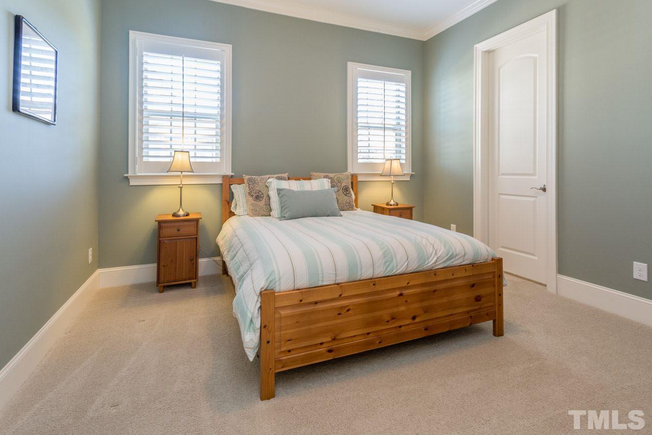 5012 Pomfret Point Raleigh, NC 27612 - Photo 19 of 25 Everyone appreciates a 1st floor guest bedroom! This room is located just off the kitchen and features planation shutters, crown molding and a private bath.