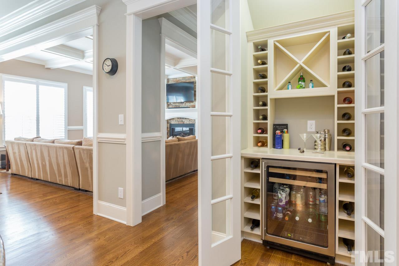 5012 Pomfret Point Raleigh, NC 27612 - Photo 8 of 25 Double glass french doors lead to the wine and bar area. What a convenient custom feature! The wine bar is located just off the kitchen right before the dining room. It offers a beverage cooler, wine racks, and a counter top for setting up drinks.