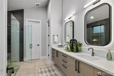 a bathroom with a double vanity sink and a mirror