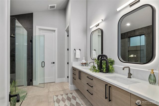 a bathroom with a double vanity sink and a mirror