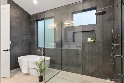 a bathroom with a bathtub and shower