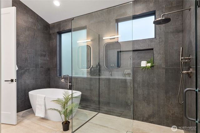a bathroom with a bathtub and shower