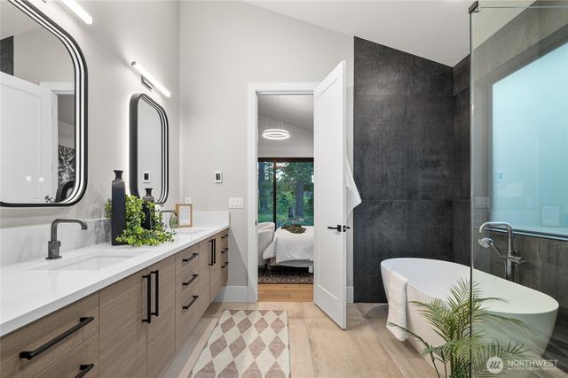 a bathroom with a double vanity sink and a mirror