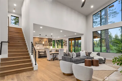 a living room with fireplace furniture and a large window