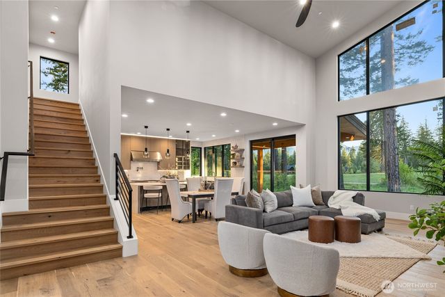 a living room with fireplace furniture and a large window