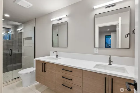 a bathroom with a sink double vanity and a shower