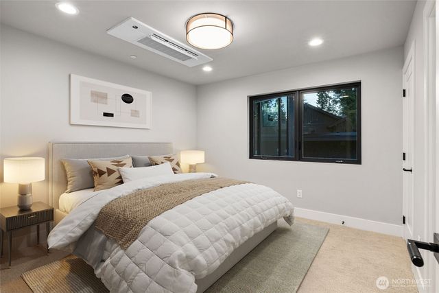 a bedroom with a large bed and a large window