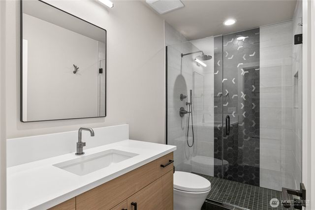 a bathroom with a sink toilet and shower