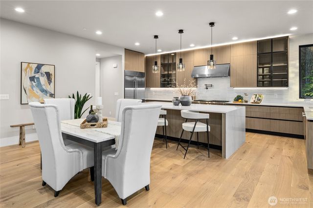 a large kitchen with a table and chairs in it