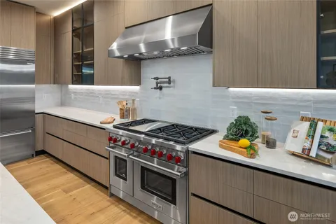 a kitchen with stainless steel appliances a stove and a sink