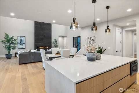 a kitchen with a counter space a sink and living room view