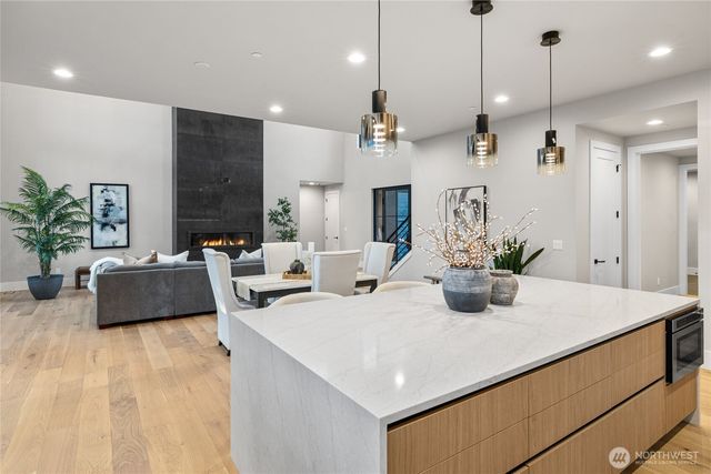 a kitchen with a counter space a sink and living room view