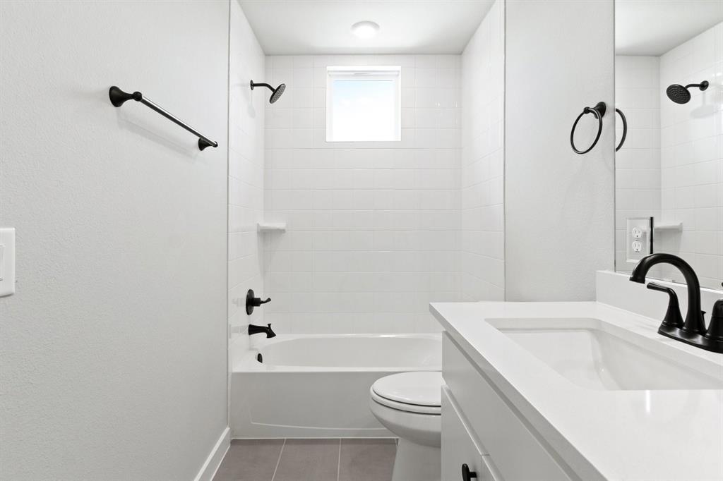 2020 Aldrich Road Celina, TX 75009 - Photo 34 of 40 a bathroom with a sink a toilet and shower