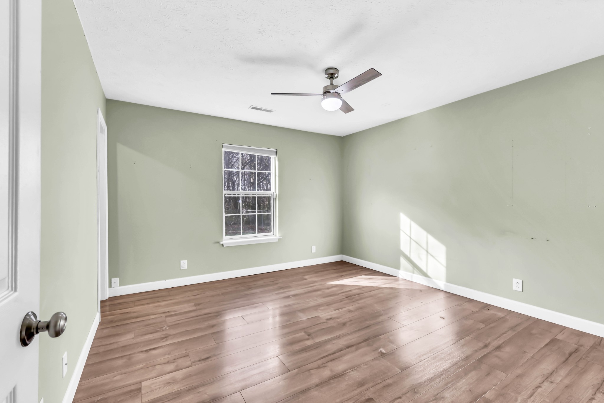 634 State Line Road Oak Grove, KY 42262 - Photo 12 of 17 an empty room with wooden floor fan and windows