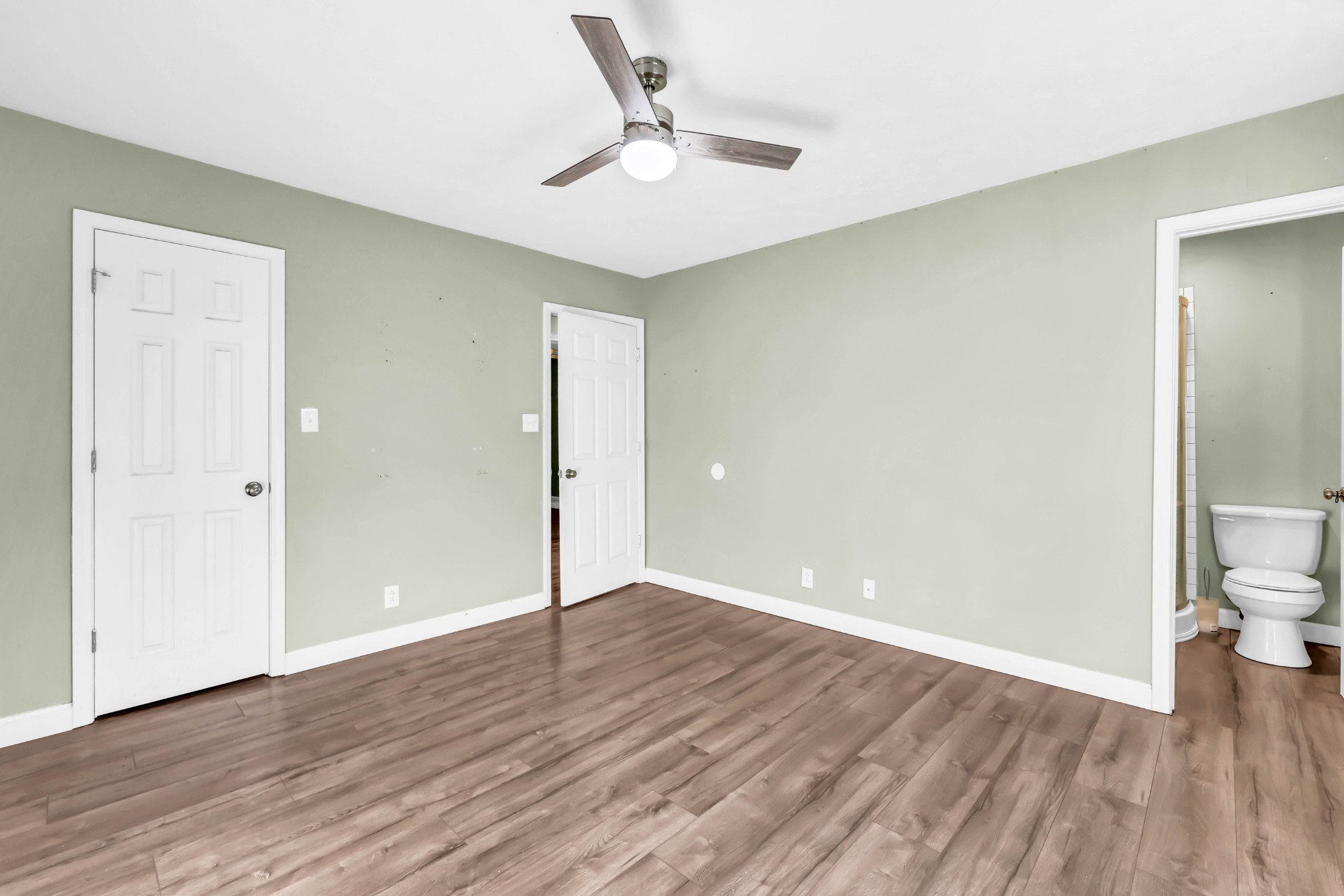 634 State Line Road Oak Grove, KY 42262 - Photo 13 of 17 an empty room with wooden floor and a ceiling fan