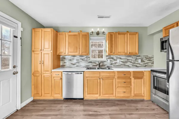 a view of granite countertop cabinets and wooden floor