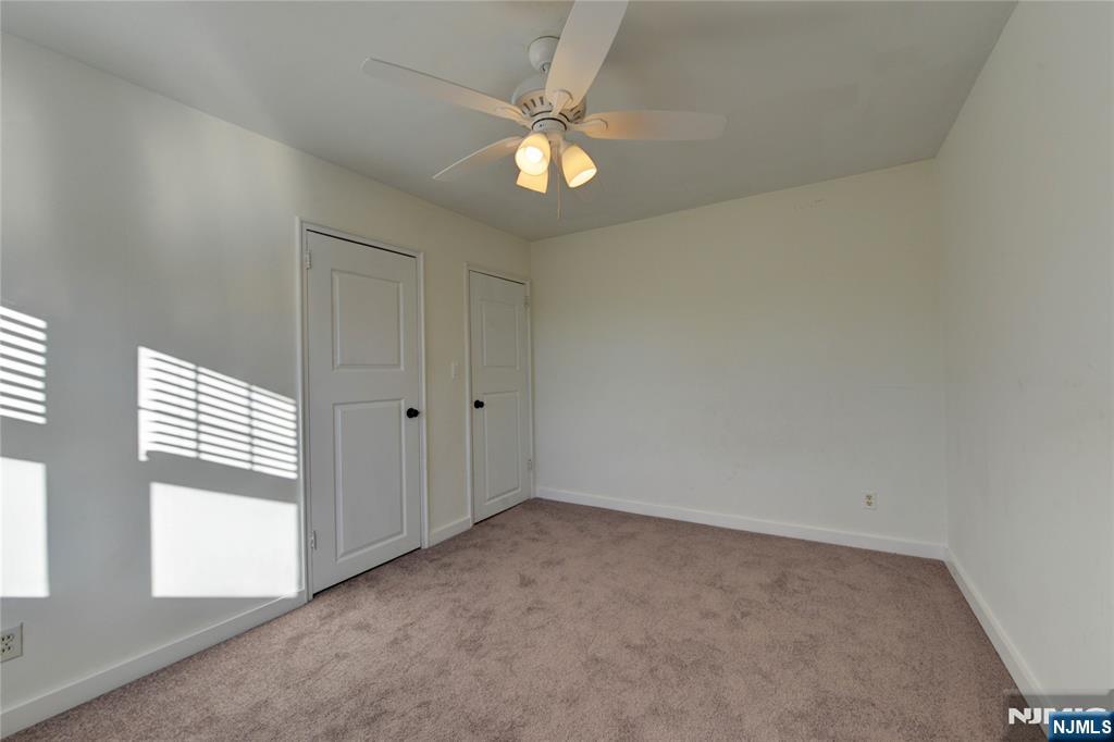 255 Bogert Road, Unit 2A River Edge, NJ 07661 - Photo 16 of 25 an empty room with windows and fan
